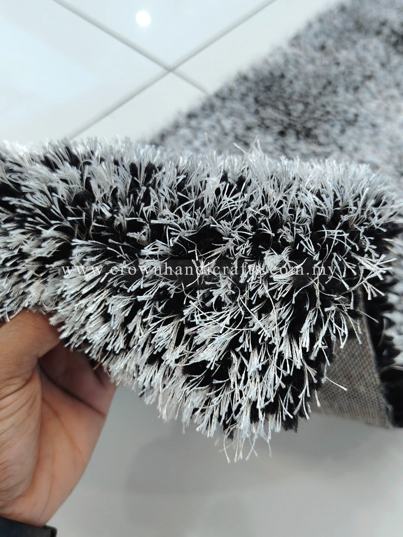 Shaggy runner rug with black-and-white high-pile fringe, close-up corner.