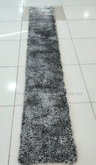 Long narrow shaggy runner rug in black-and-white, centered on tiled floor