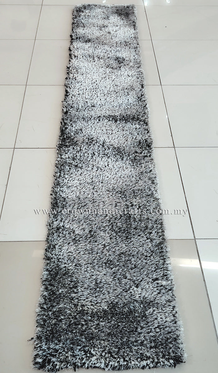 Long narrow shaggy runner rug with mottled black-and-white pile, full view