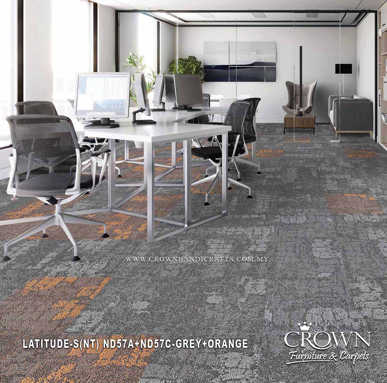Grey and orange patterned carpet tiles in a modern office with desks and seating
