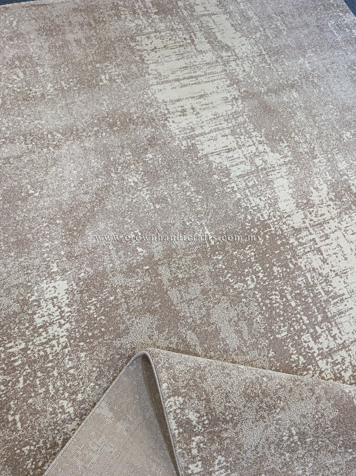 Abstract area rug with distressed beige and white design, rolled corner visible.
