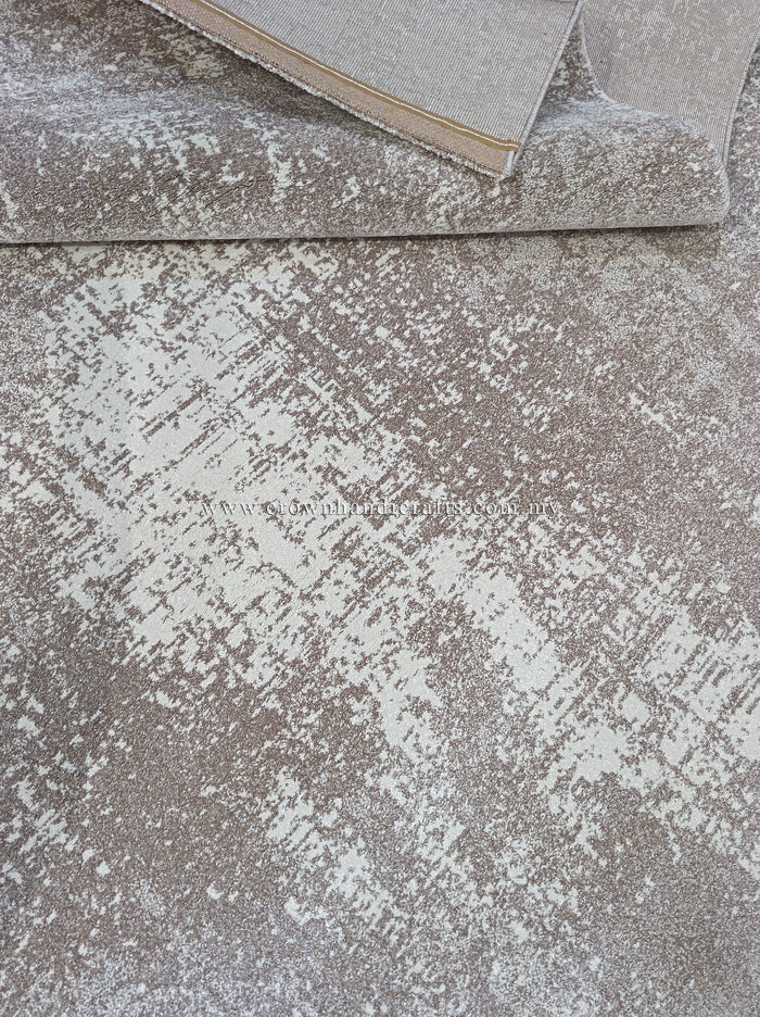 Abstract area rug with distressed beige and white pattern, binding edge detail.