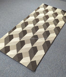 Geometric hallway runner rug with cream, brown, and gray cube pattern