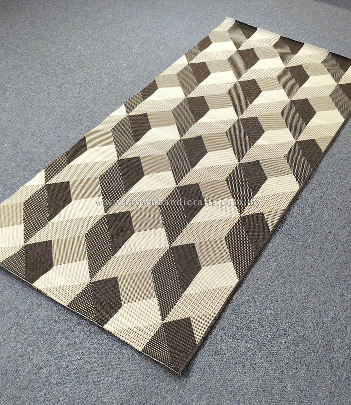 Geometric hallway runner rug with cream, brown, and gray cube pattern