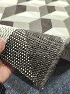 Textured runner rug edge detail in dark brown with cream speckled weave