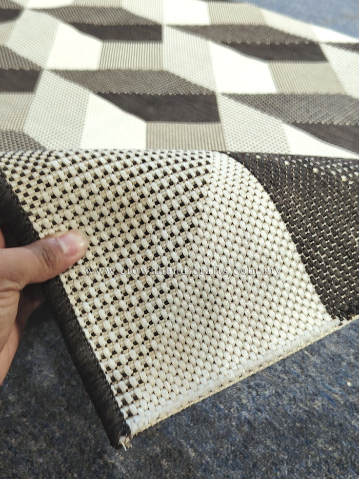 Woven runner rug corner with cream and dark brown checker-cube pattern