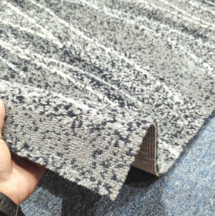 Abstract runner carpet, beige and dark speckled surface with stripe pattern, rolled edge.