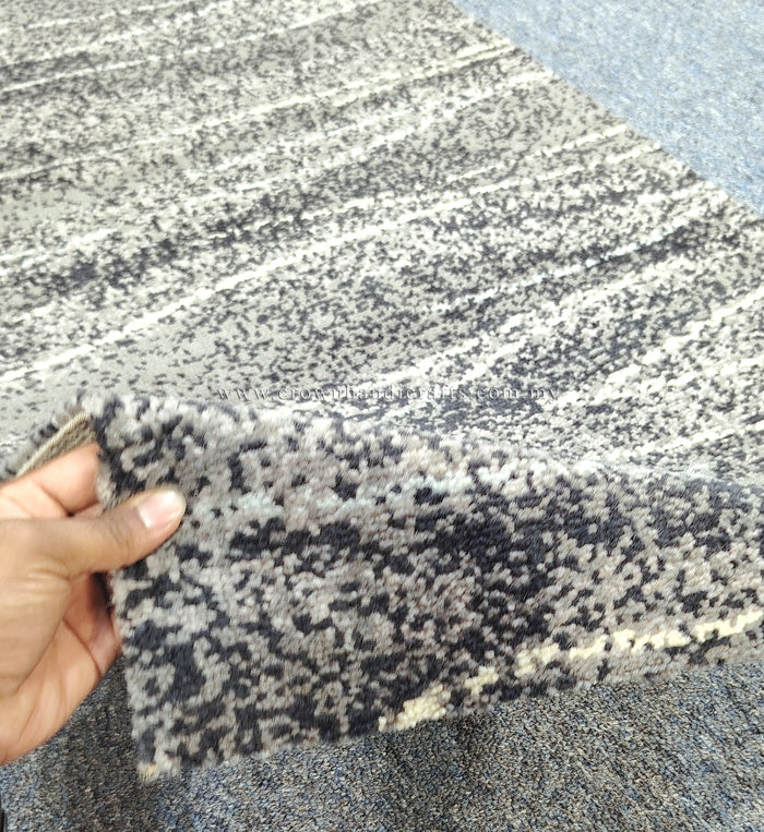 Abstract runner carpet edge detail, beige with dark speckled dots and striped motif.
