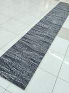 Long abstract runner rug, dark blue-gray with layered stripe and speckle pattern
