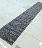 Abstract runner rug with dark blue-gray stripes and speckled texture, long hall size