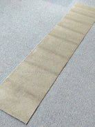 Beige runner rug with smooth texture, flat woven look, and straight borders