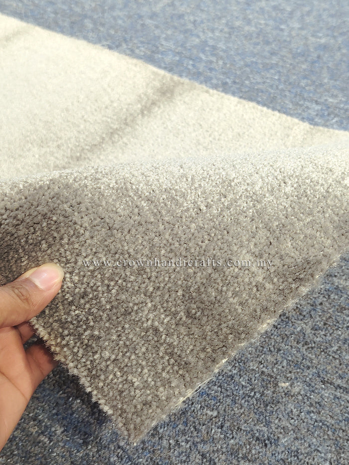 Grey runner rug with dense textured pile and stitched edge detail close-up