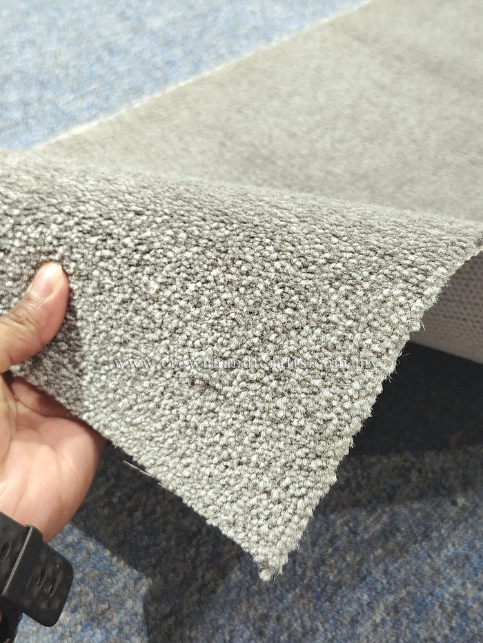 Light grey runner rug corner with dense looped pile and clean straight edge