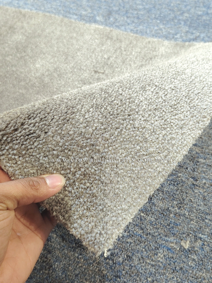 Light grey textured runner rug corner detail, showing cut pile and short pile density