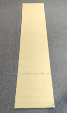 Beige runner rug, full length view with uniform flat woven pile