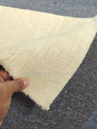 Beige runner rug close-up with plush shag pile texture