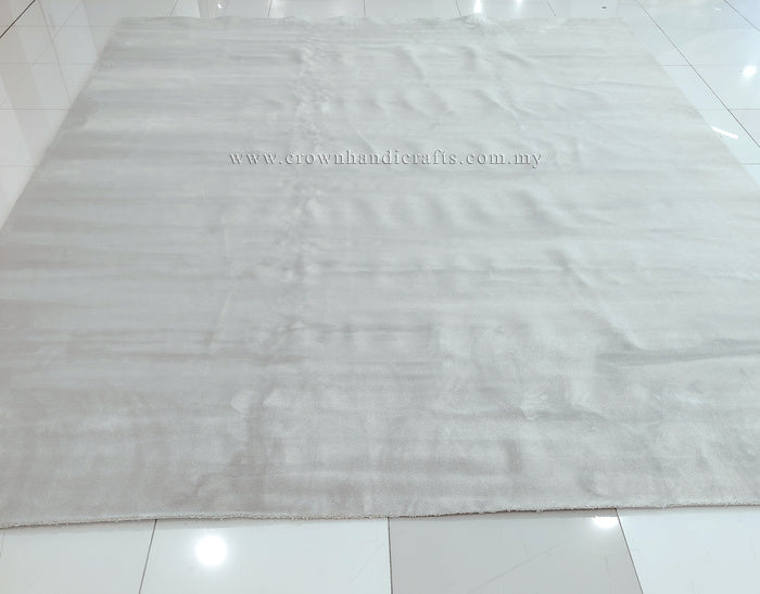Large oatmeal-beige area rug laid flat with low, even pile