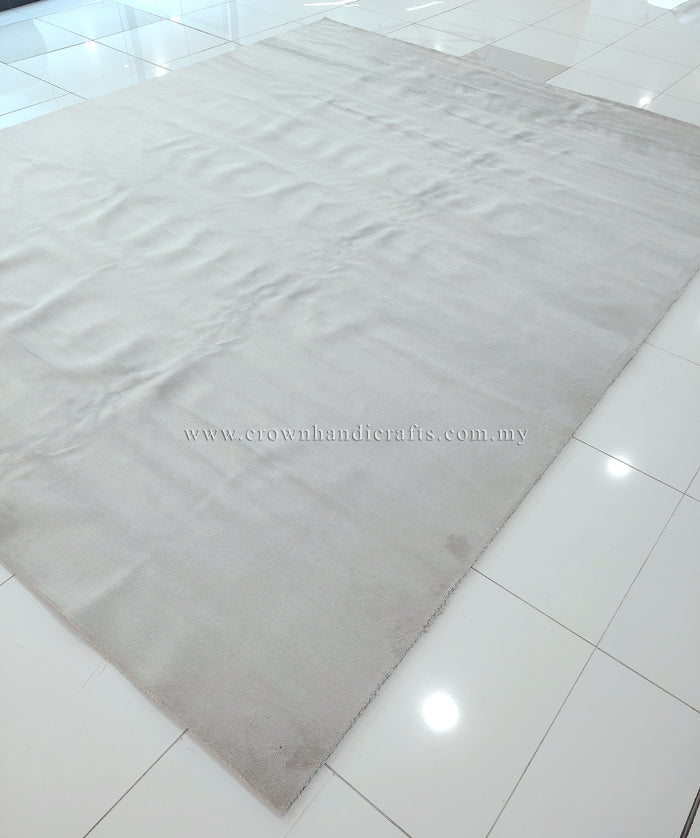 Large oatmeal-beige area rug laid out flat with textured, plush pile