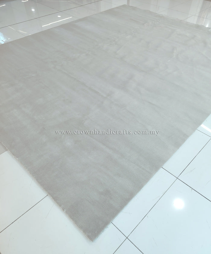 Large oatmeal-beige area rug with smooth low pile and subtle pattern