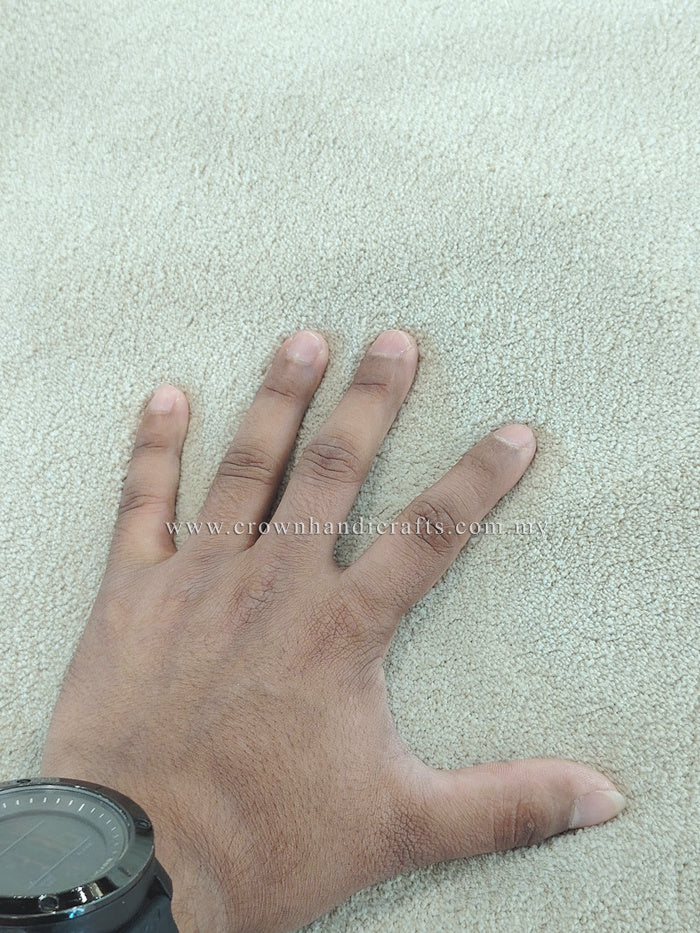 Oatmeal-beige rug surface with dense pile texture; hand pressing fabric