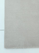Oatmeal-beige area rug with soft shag pile and clean border