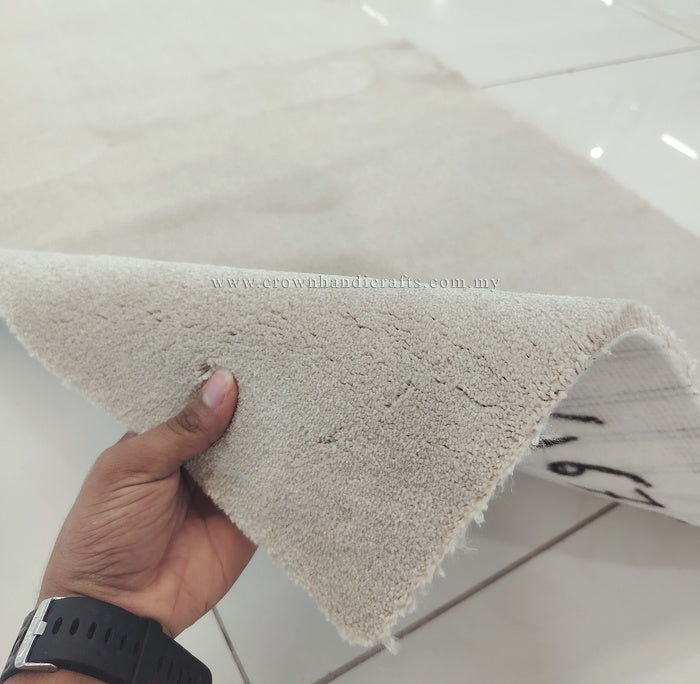 Oatmeal beige runner rug corner detail, fingers holding plush textured pile