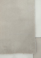 Oatmeal beige soft runner rug, close-up of textured short pile edge