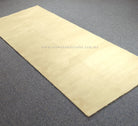 Cream hallway runner rug folded flat, smooth surface and clean hem edges
