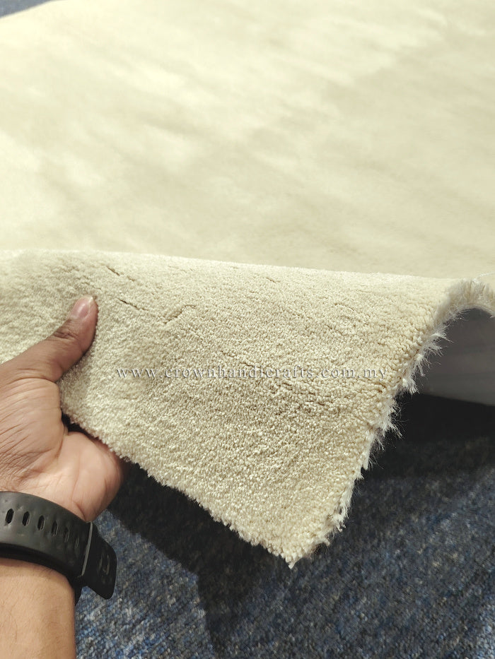 Cream runner rug corner with short shag pile and frayed backing edge