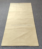 Oatmeal-beige runner rug rectangular shape with smooth, short pile finish