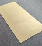 Oatmeal-beige runner rug angled view with uniform texture and frayed edge