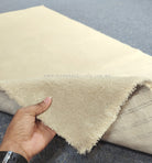 Oatmeal-beige runner rug showing soft cut-pile texture and folded edge