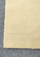 Oatmeal-beige runner rug with soft, short pile and visible border edge