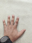 Oatmeal-beige runner rug close-up with textured pile and corner edge