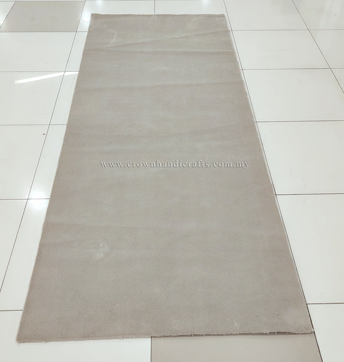 Oatmeal beige long area rug laid flat, low pile with neat, straight border