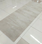 Oatmeal beige runner-style area rug with smooth low-pile surface and clean hem