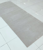 Oatmeal beige long area rug with subtle tonal pattern and uniform low pile