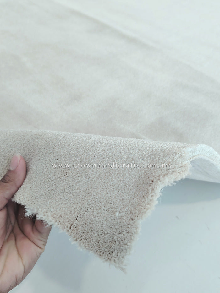 Oatmeal beige area rug corner with short fringed trim and low, dense pile