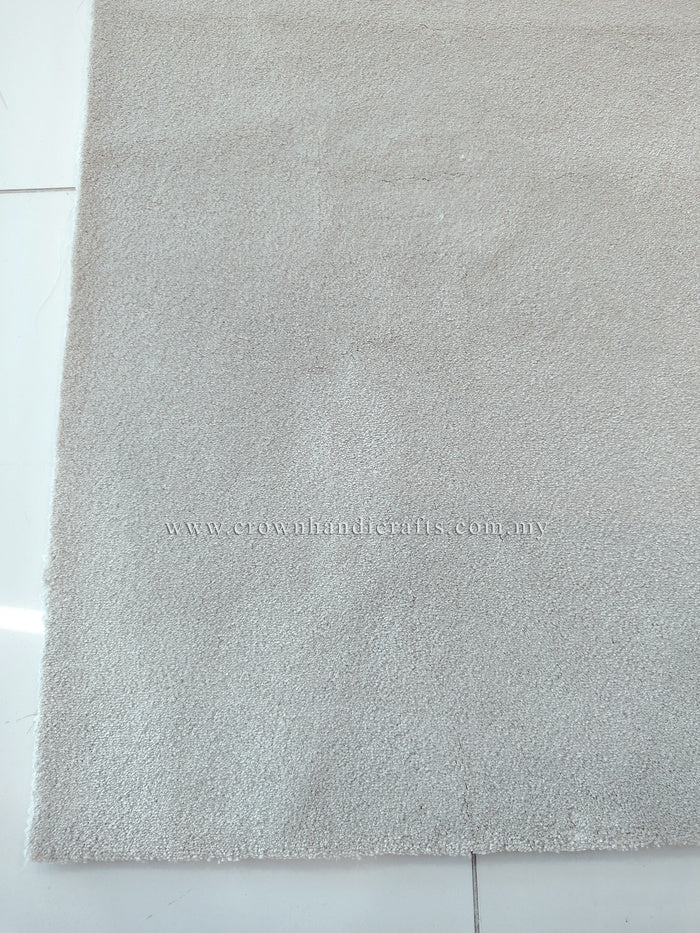 Oatmeal beige textured area rug with even low pile and straight border edge