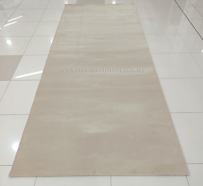 Long cream area rug laid out flat with uniform texture across the surface