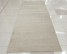 Cream area rug with smooth low pile and even color tone