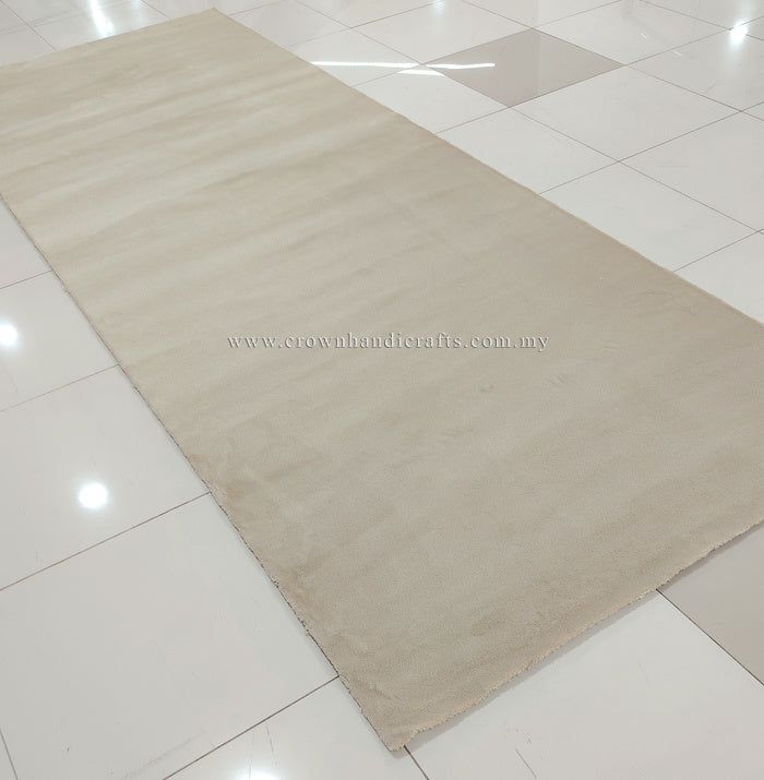 Cream area rug close view with low pile texture and finished border