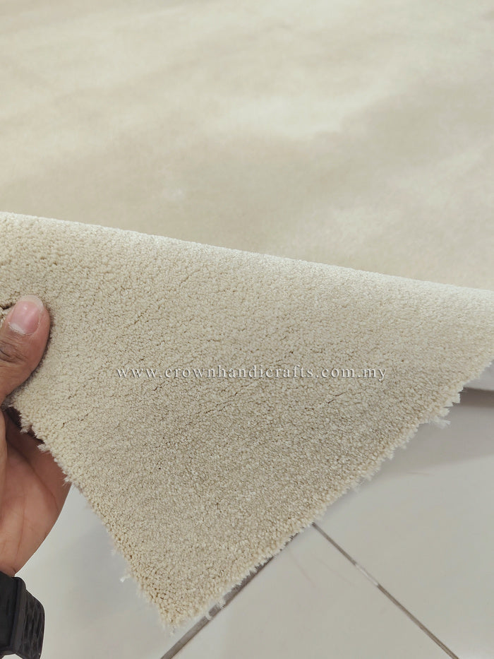 Cream area rug corner detail with low pile and neatly finished edge