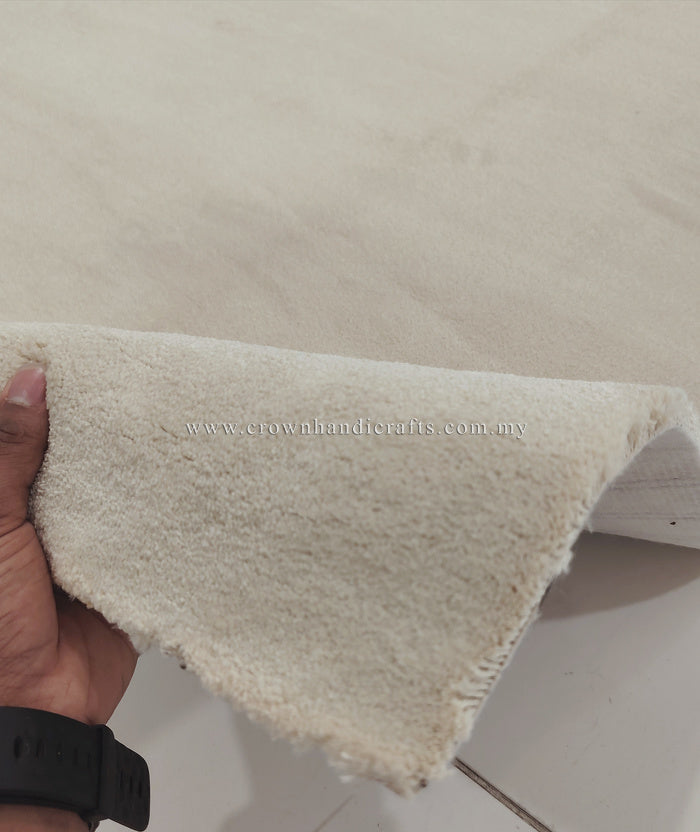 Cream area rug edge detail showing underside gap and short textured pile