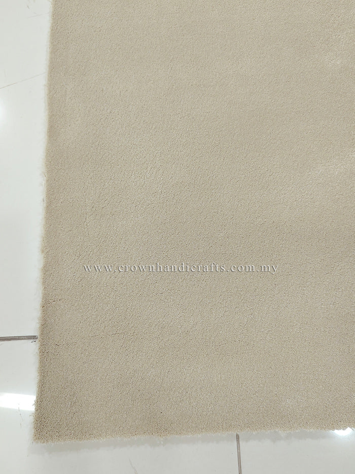Cream area rug with short textured pile and straight edge