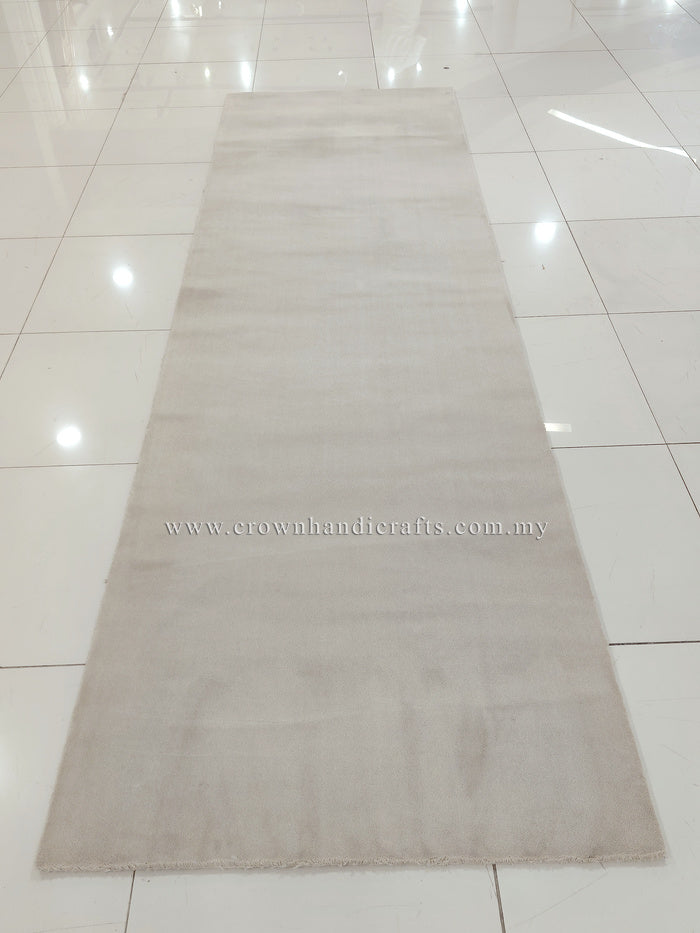 Oatmeal beige runner rug, full view with low pile and short fringe detailing.
