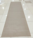 Oatmeal beige long runner rug, full layout view with smooth low pile and straight edges.