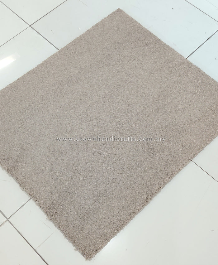 Soft brown fluffy shag rug, single square corner view on tiled floor