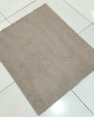 Soft brown shag rug with short plush pile, straight-on square view