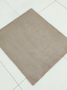 Soft shaggy accent rug with dense short pile, taupe brown square on tile floor